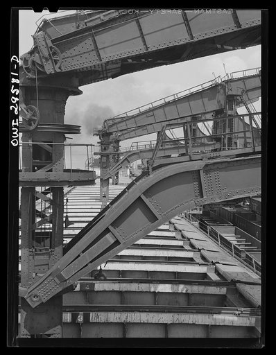 Cleveland, Ohio. Unloading a lake freighter by means of Hewlett [i.e., Hulett] unloaders at the Pennsylvania Railroad iron ore docks
