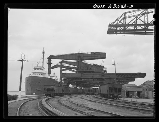 Untitled photo, possibly related to: Cleveland, Ohio. Unloading a lake freighter by means of Hewlett [i.e., Hulett] unloaders at the Pennsylvania Railroad iron ore docks
