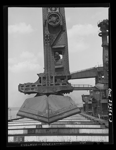 Untitled photo, possibly related to: Cleveland, Ohio. Unloading a lake freighter by means of Hewlett [i.e., Hulett] unloaders at the Pennsylvania Railroad iron ore docks