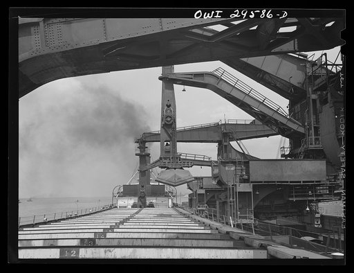 Cleveland, Ohio. Unloading a lake freighter by means of Hewlett [i.e., Hulett] unloaders at the Pennsylvania Railroad iron ore docks