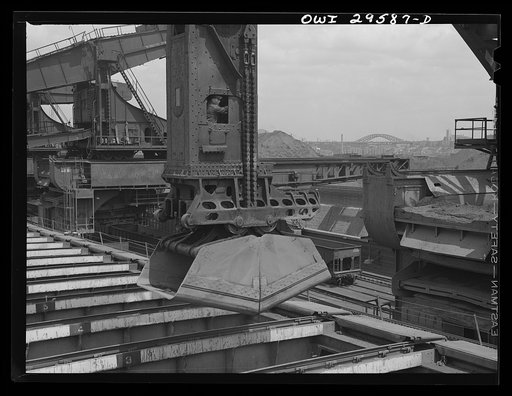 Cleveland, Ohio. Unloading a lake freighter by means of Hewlett [i.e., Hulett] unloaders at the Pennsylvania Railroad iron ore docks