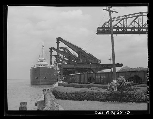 Untitled photo, possibly related to: Cleveland, Ohio. Unloading a lake freighter by means of Hewlett [i.e., Hulett] unloaders at the Pennsylvania Railroad iron ore docks