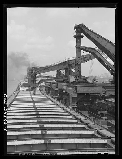 Untitled photo, possibly related to: Cleveland, Ohio. Unloading a lake freighter by means of Hewlett [i.e., Hulett] unloaders at the Pennsylvania Railroad iron ore docks