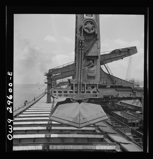 Cleveland, Ohio. Unloading iron ore from a lake freighter by means of Hewlett [i.e., Hulett] unloaders at the Pennsylvania Railroad docks