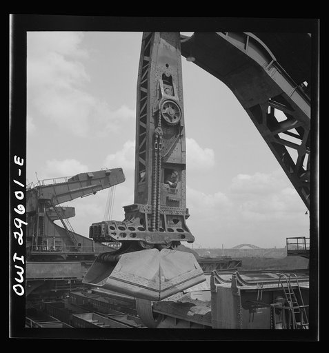 Cleveland, Ohio. Unloading iron ore from a lake freighter by means of Hewlett [i.e., Hulett] unloaders at the Pennsylvania Railroad docks