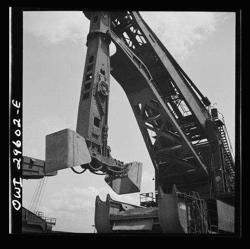 Untitled photo, possibly related to: Cleveland, Ohio. Unloading a lake freighter by means of Hewlett [i.e., Hulett] unloaders at the Pennsylvania Railroad iron ore docks