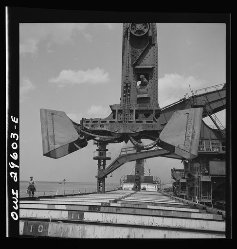 Cleveland, Ohio. Unloading iron ore from a lake freighter by means of Hewlett [i.e., Hulett] unloaders at the Pennsylvania Railroad docks