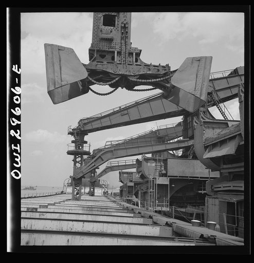 Cleveland, Ohio. Unloading iron ore from a lake freighter by means of Hewlett [i.e., Hulett] unloaders at the Pennsylvania Railroad docks