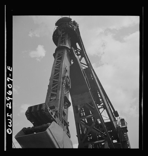 Untitled photo, possibly related to: Cleveland, Ohio. Unloading a lake freighter by means of Hewlett [i.e., Hulett] unloaders at the Pennsylvania Railroad iron ore docks