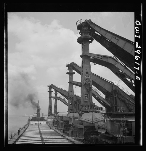 Cleveland, Ohio. Unloading iron ore from a lake freighter by means of Hewlett [i.e., Hulett] unloaders at the Pennsylvania Railroad docks