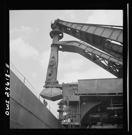 Cleveland, Ohio. Unloading iron ore from a lake freighter by means of Hewlett [i.e., Hulett] unloaders at the Pennsylvania Railroad docks