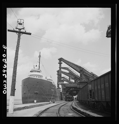 Untitled photo, possibly related to: Cleveland, Ohio. Unloading a lake freighter by means of Hewlett [i.e., Hulett] unloaders at the Pennsylvania Railroad iron ore docks