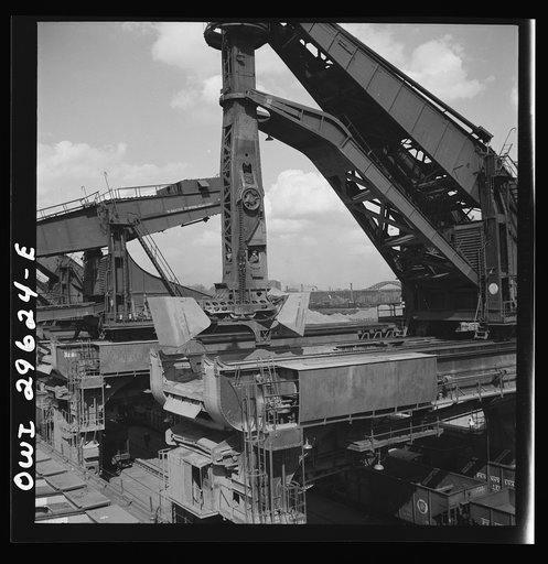 Cleveland, Ohio. Unloading iron ore from a lake freighter by means of Hewlett [i.e., Hulett] unloaders at the Pennsylvania Railroad docks