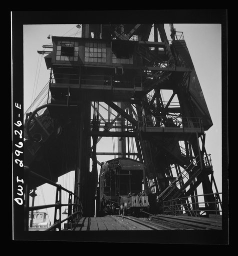 Untitled photo, possibly related to: Sandusky, Ohio. A carload of coal at the loading machine at the Pennsylvania Railroad dock