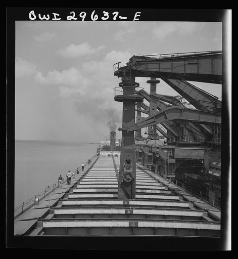 Cleveland, Ohio. Unloading iron ore from a lake freighter by means of Hewlett [i.e., Hulett] unloaders at the Pennsylvania Railroad docks