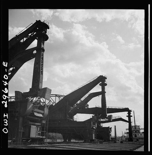 Cleveland, Ohio. Unloading iron ore from a lake freighter by means of Hewlett [i.e., Hulett] unloaders at the Pennsylvania Railroad docks