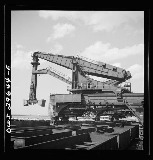 Cleveland, Ohio. Unloading iron ore from a lake freighter by means of Hewlett [i.e., Hulett] unloaders at the Pennsylvania Railroad docks