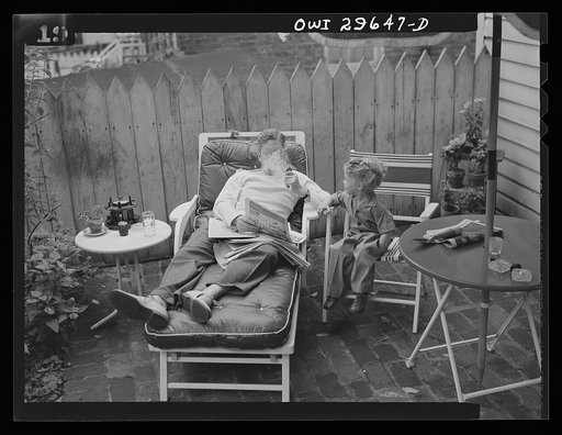 Untitled photo, possibly related to: Alexandria, Virginia. Father and son reading the Sunday newspaper. Scenes similar to this are found all over the United States because of wartime transportation problems