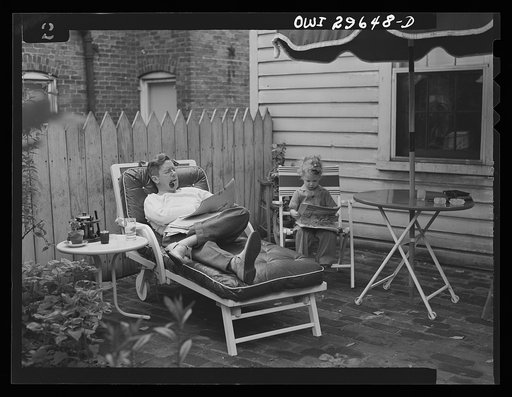Alexandria, Virginia. Father and son reading the Sunday newspaper. Scenes similar to this are found all over the United States because of wartime transportation problems