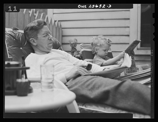 Untitled photo, possibly related to: Alexandria, Virginia. Father and son talking on a Sunday afternoon. Scenes similar to this are found all over the United States because of wartime transportation problems