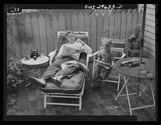 Untitled photo, possibly related to: Alexandria, Virginia. Father and son reading the Sunday newspaper. Scenes similar to this are found all over the United States because of wartime transportation problems