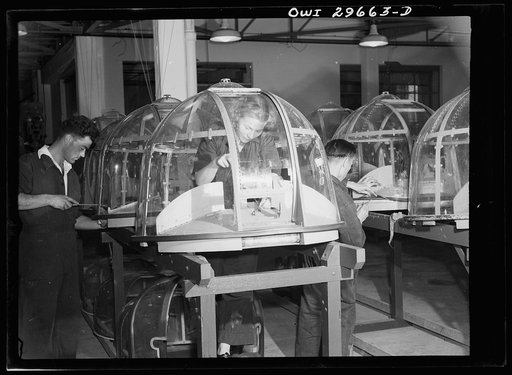 Untitled photo, possibly related to: Melbourne, Australia. Beaufort torpedo bomber turret sub-assembly plant. Men and women workmen putting finishing touches on turrets. All the transparent lucite and metal reinforcement strips used in these turrets were imported under the lend lease program
