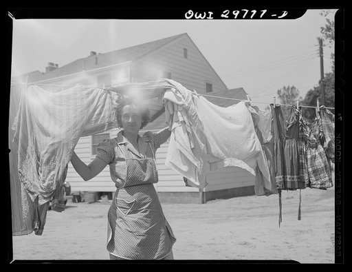 Untitled photo, possibly related to: Point Pleasant, West Virginia. Mrs. Fergusen hanging out her wash. The victory garden is in the foreground