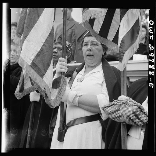 Arlington Cemetery, Arlington, Virginia. An American Legion color bearer singing "America" in the amphitheater