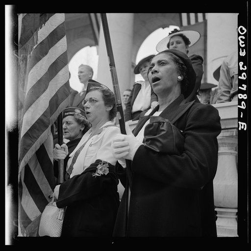 Arlington Cemetery, Arlington, Virginia. An American Legion color bearer singing "America" in the amphitheater