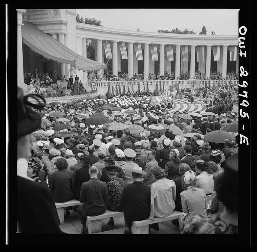 Arlington Cemetery, Arlington, Virginia. Spectators putting up umbrellas as a light rain starts falling at the Memorial Day services in the amphitheater