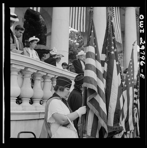 Untitled photo, possibly related to: Arlington Cemetery, Arlington, Virginia. American Legion color bearer listening to "Taps" being played at the Memorial services in the amphitheater