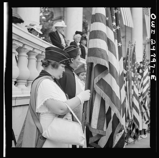 Untitled photo, possibly related to: Arlington Cemetery, Arlington, Virginia. American Legion color bearer listening to "Taps" being played at the Memorial services in the amphitheater