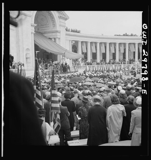 Untitled photo, possibly related to: Arlington Cemetery, Arlington, Virginia. Spectators putting up umbrellas as a light rain starts falling at the Memorial Day services in the amphitheater