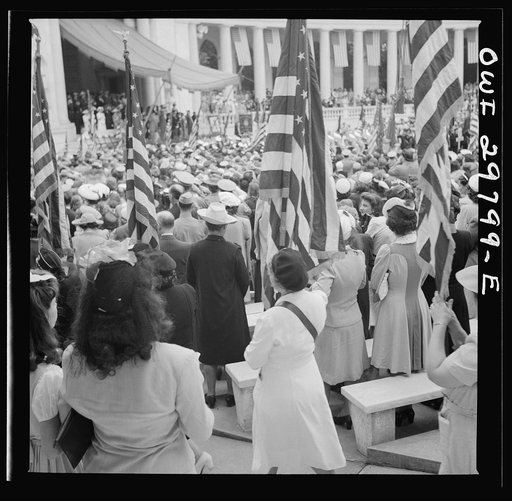 Untitled photo, possibly related to: Arlington Cemetery, Arlington, Virginia. Spectators putting up umbrellas as a light rain starts falling at the Memorial Day services in the amphitheater