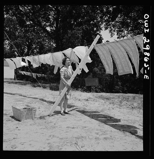 Point Pleasant, West Virginia. Mrs. Fergusen putting a pole on the clothes line