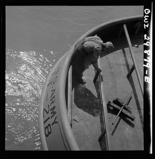 Untitled photo, possibly related to: Point Pleasant, West Virginia. Scraping steel on a United States Army LT boat
