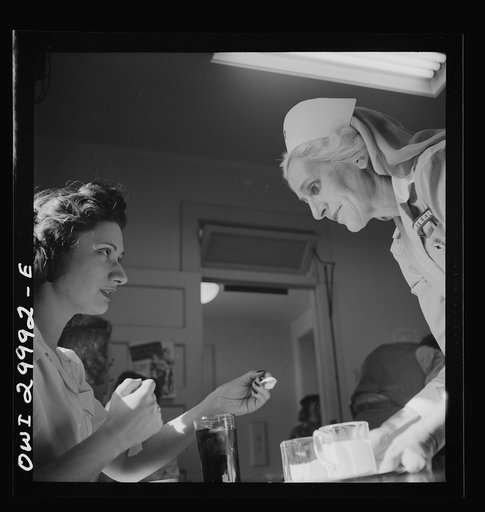 Washington, D.C. American Red Cross volunteer nurse's aide offering refreshments to a blood donor at the center