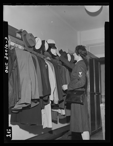 Washington, D.C. A WAVE (Women Accepted for Volunteer Emergency Service) hangs her hat at the American Red Cross blood donor center prior to giving blood to the bank