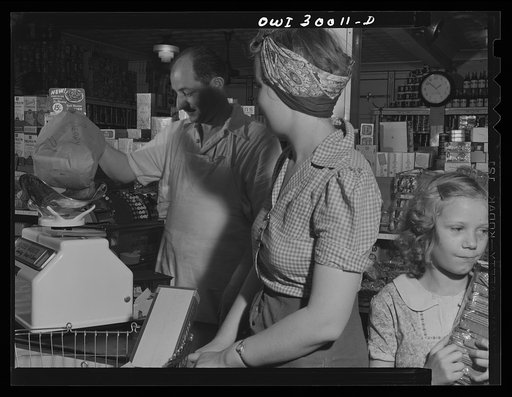 Untitled photo, possibly related to: Washington, D.C. These metal and glass containers are commercially made. One is used for blue stamps, the other for red stamps which must be surrendered by customers under the point rationing system