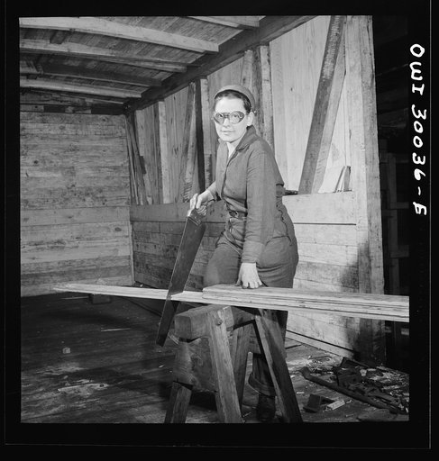 Pitcairn, Pennsylvania. Mrs. Hazel Reed, thirty, employed as a car repairman's helper in the Pennsylvania Railroad yards, earning seventy-two cents per hour. She is repairing a wooden boxcar. Mrs. Reed's husband is in the United States Army
