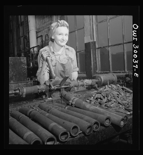 Pitcairn, Pennsylvania. Mrs. Julia Sabo, thirty-five, mother of three children, employed as a machinist's helper in the Pennsylvania Railroad yards, earning seventy-two cents per hour. She is splicing a reclaimed air brake hose