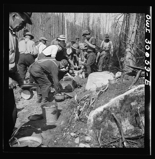 Spring pulpwood drive on the Brown Company timber holdings in Maine. At ten o'clock and two o'clock woodsmen eat near their work, serving themselves cafeteria style