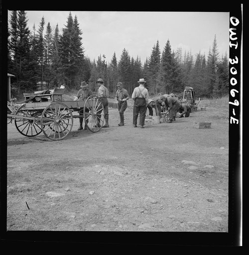 Spring pulpwood drive on the Brown Company timber holdings in Maine. Mid-afternoon lunch brought by wagon from camp to where the men are cooking