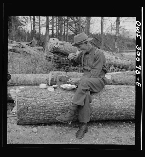 Spring pulpwood drive on the Brown Company timber holdings in Maine. Mid-afternoon "lunch" by Long Pond where woodsmen are sluicing. On the menu that day: roast pork and dressing, boiled potatoes, turnips, baked beans, hot cakes, hot biscuits, bread, butter, cookies, apple pie, orange pie, milk, tea