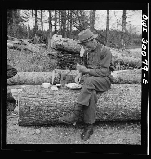 Untitled photo, possibly related to: Spring pulpwood drive on the Brown Company timber holdings in Maine. Mid-afternoon "lunch" by Long Pond where woodsmen are sluicing. On the menu that day: roast pork and dressing, boiled potatoes, turnips, baked beans, hot cakes, hot biscuits, bread, butter, cook