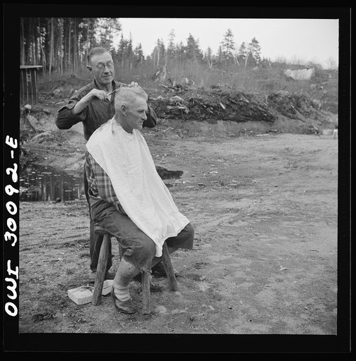 Spring pulpwood drive on the Brown Company timber holdings in Maine. Camp handy man is conveniently handy with the scissors; the nearest professional barber is thirty-five miles away