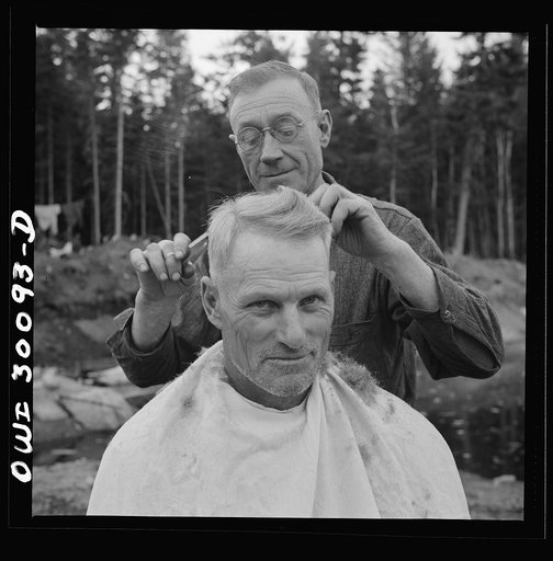 Spring pulpwood drive on the Brown Company timber holdings in Maine. Camp handy man is conveniently handy with the scissors; the nearest professional barber is thirty-five miles away