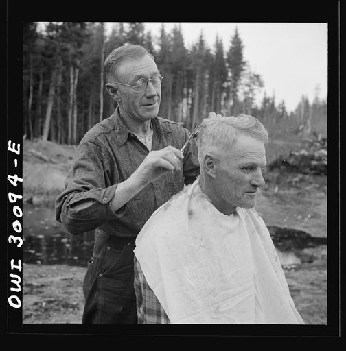 Spring pulpwood drive on the Brown Company timber holdings in Maine. Camp handy man is conveniently handy with the scissors; the nearest professional barber is thirty-five miles away