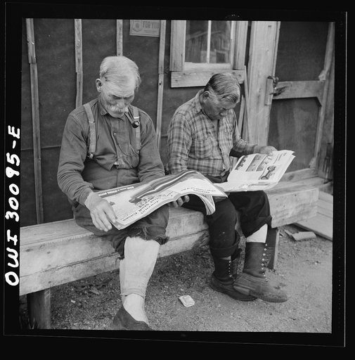Untitled photo, possibly related to: Spring pulpwood drive on the Brown Company timber holdings in Maine. Woodsmen taking it easy in front of the bunkhouse before dinner
