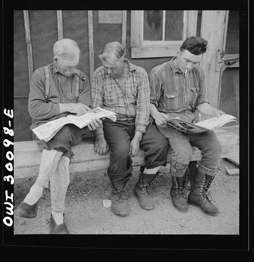 Spring pulpwood drive on the Brown Company timber holdings in Maine. Woodsmen take off or unlace their heavy shoes when they have a short time to themselves before supper